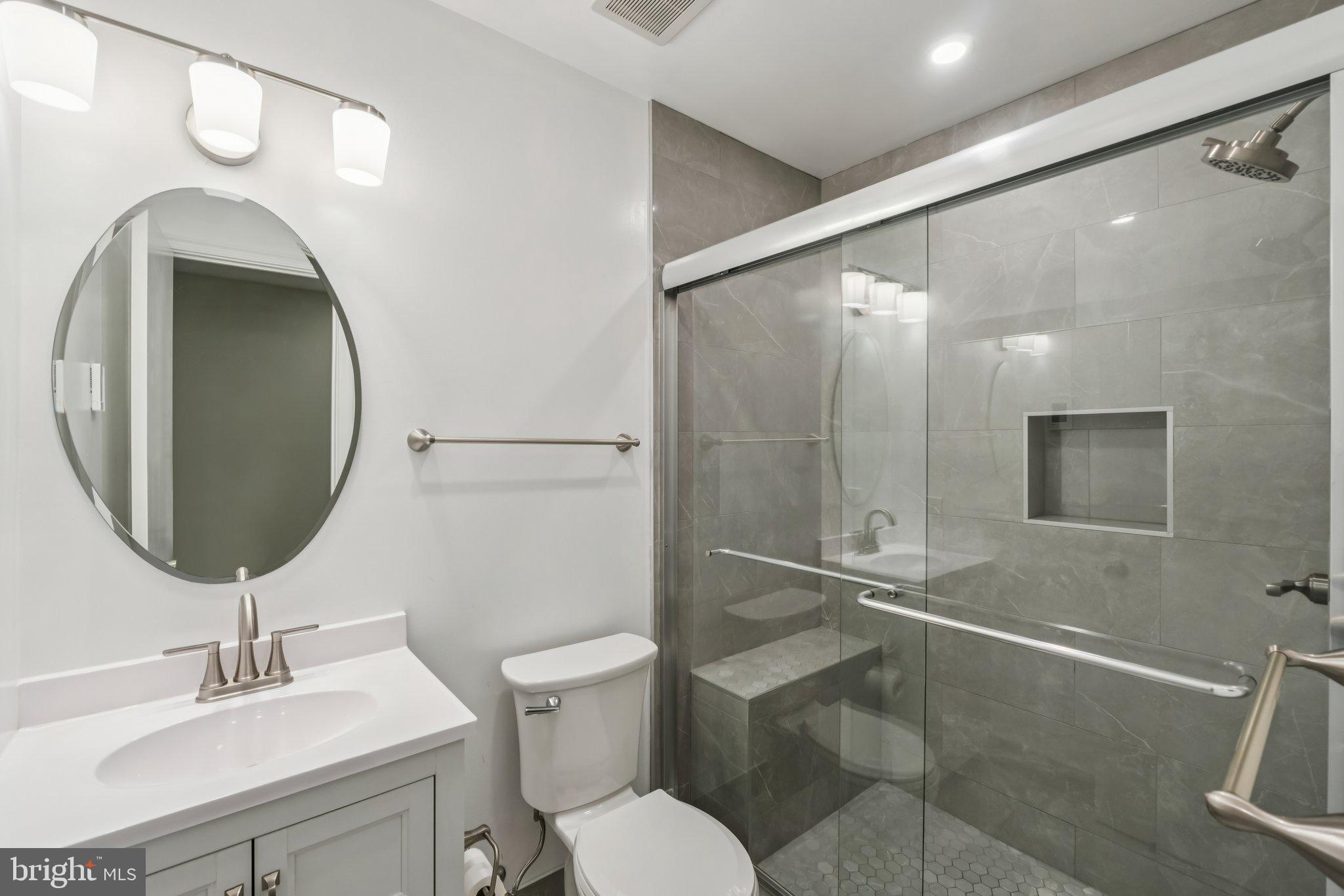 3437 Summit Court Northeast, Unit 3437 Washington, DC 20018 - Photo 19 of 26 a bathroom with a toilet sink and mirror