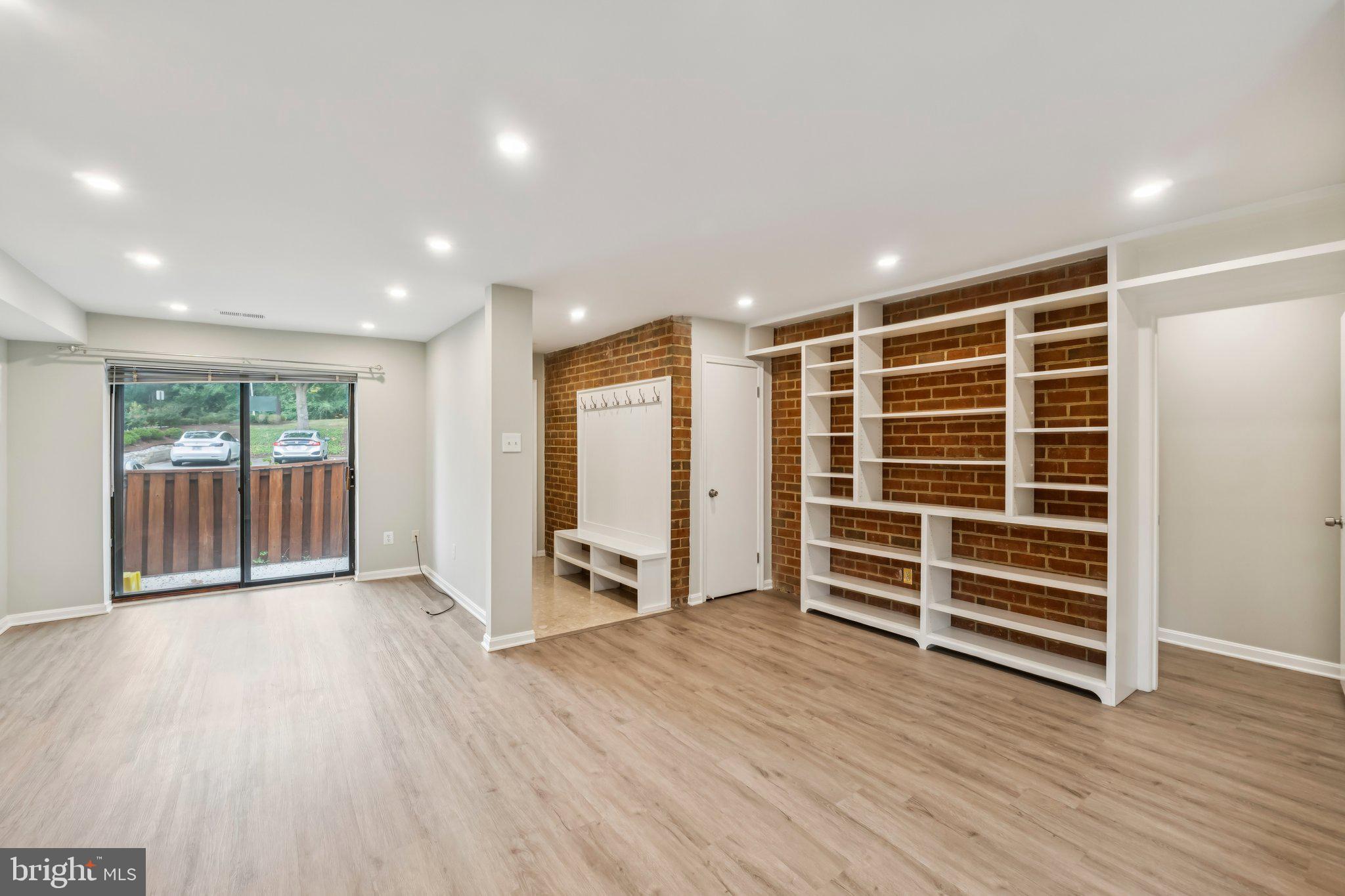 3437 Summit Court Northeast, Unit 3437 Washington, DC 20018 - Photo 2 of 26 an empty room with wooden floor and windows