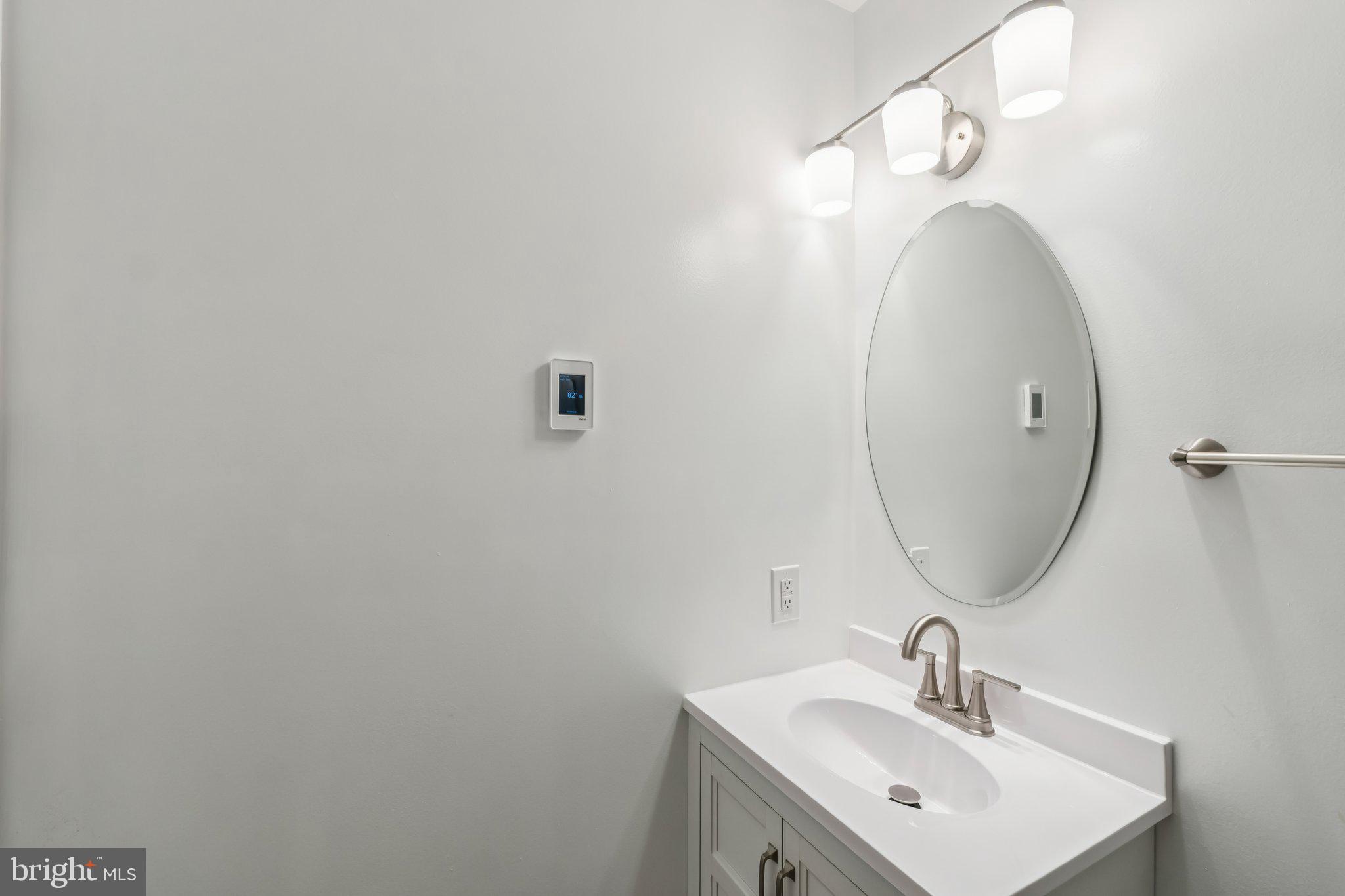 3437 Summit Court Northeast, Unit 3437 Washington, DC 20018 - Photo 21 of 26 a bathroom with a sink and a mirror