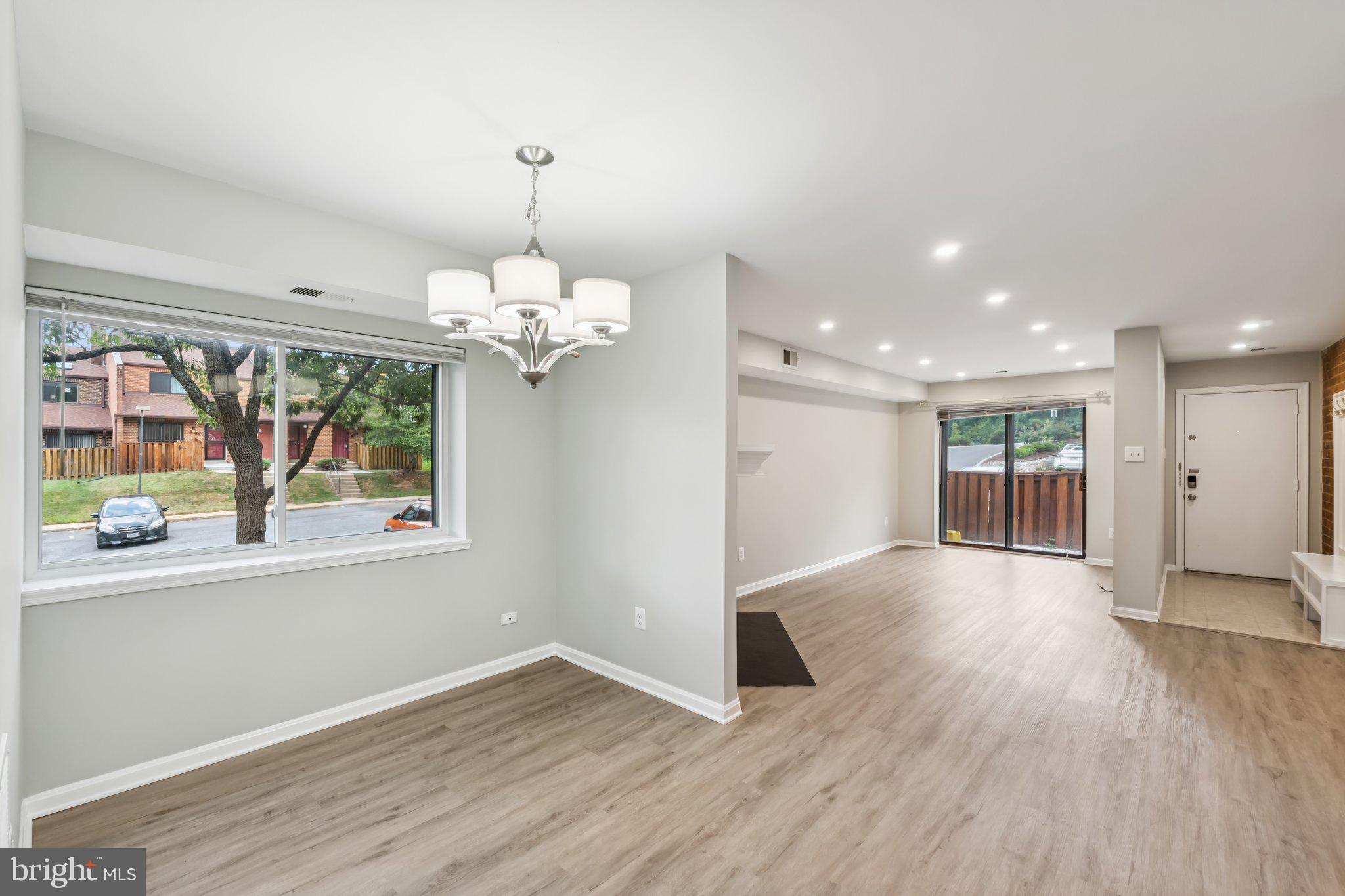3437 Summit Court Northeast, Unit 3437 Washington, DC 20018 - Photo 3 of 26 a view of an empty room with wooden floor and a window