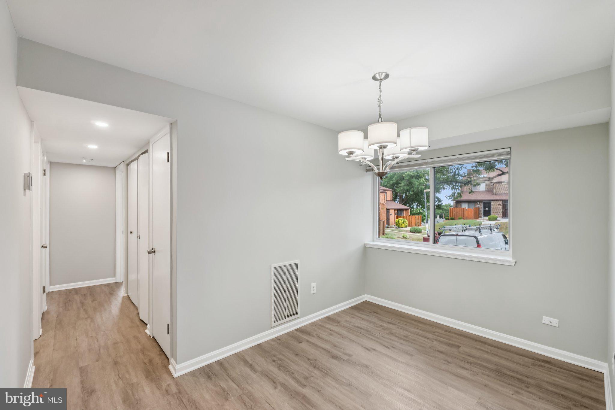 3437 Summit Court Northeast, Unit 3437 Washington, DC 20018 - Photo 8 of 26 a view of livingroom with chandelier and wooden floor