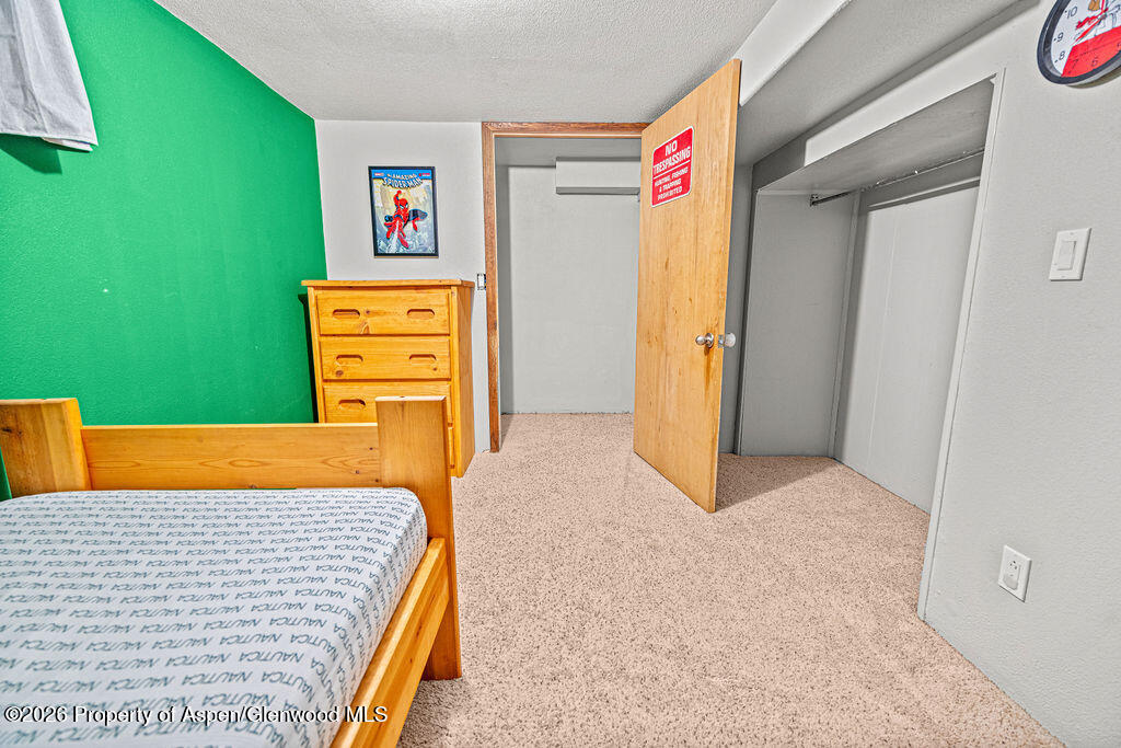 761 Rose Street Craig, CO 81625 - Photo 20 of 46 a bedroom with a bed and a dresser