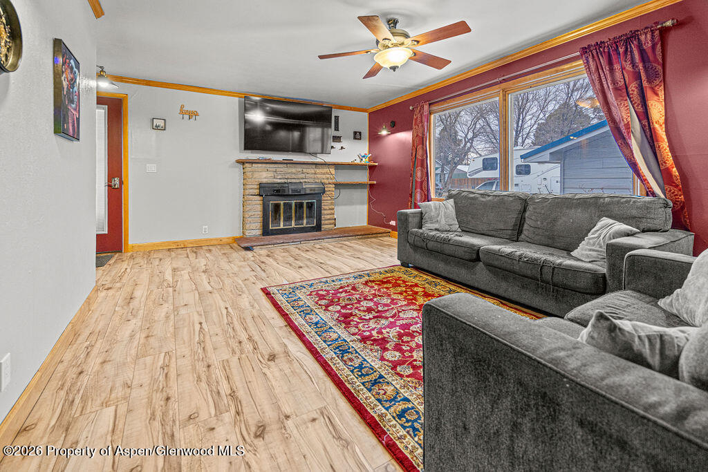 761 Rose Street Craig, CO 81625 - Photo 10 of 46 a living room with furniture a fireplace and a flat screen tv