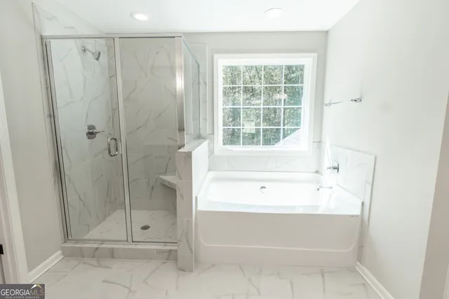 a bathroom with a shower and a bathtub