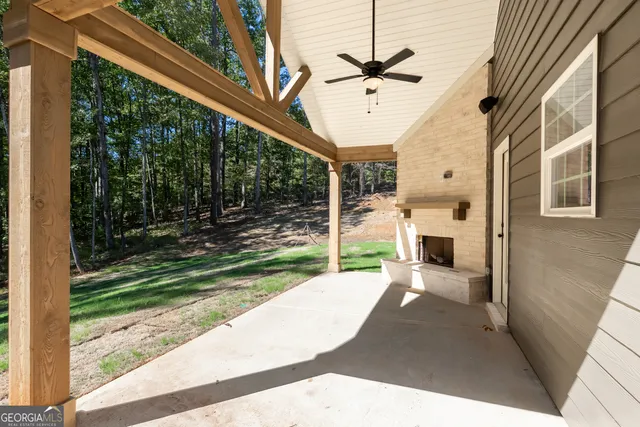 a view of a porch with couches and wooden fence