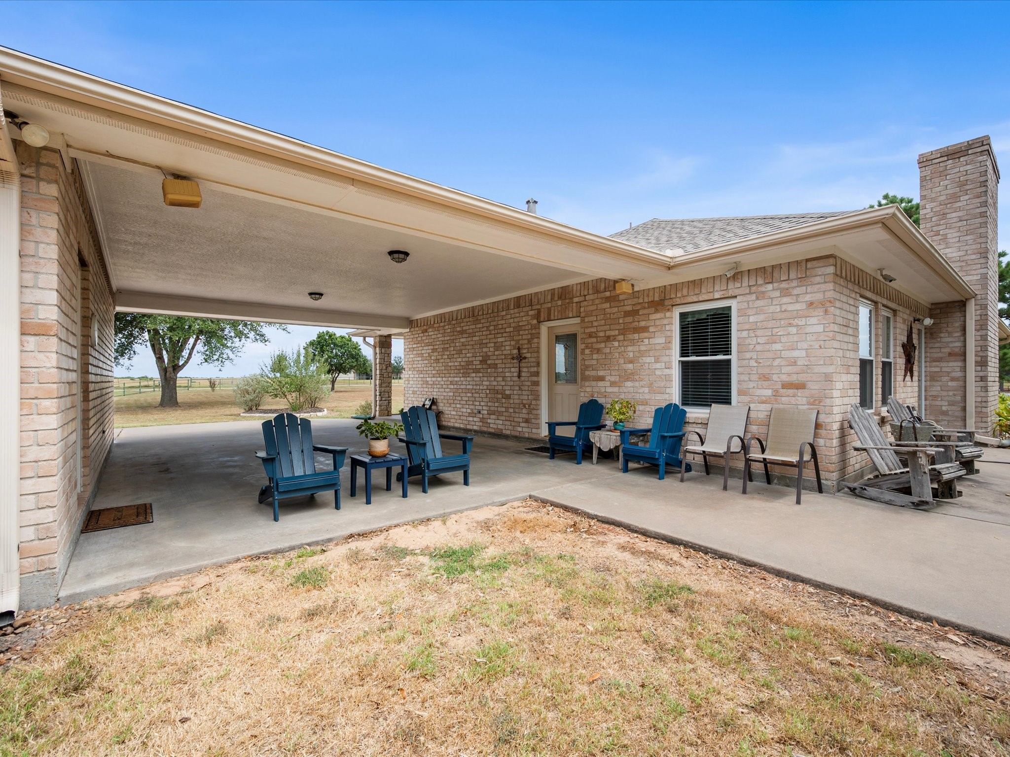 19929 Pierceall Road Hempstead, TX 77445 - Photo 9 of 50 The porte-cochere offers more than covered access—it creates a peaceful gathering space for enjoying a morning sunrise, evening sunset, or time with friends and loved ones.