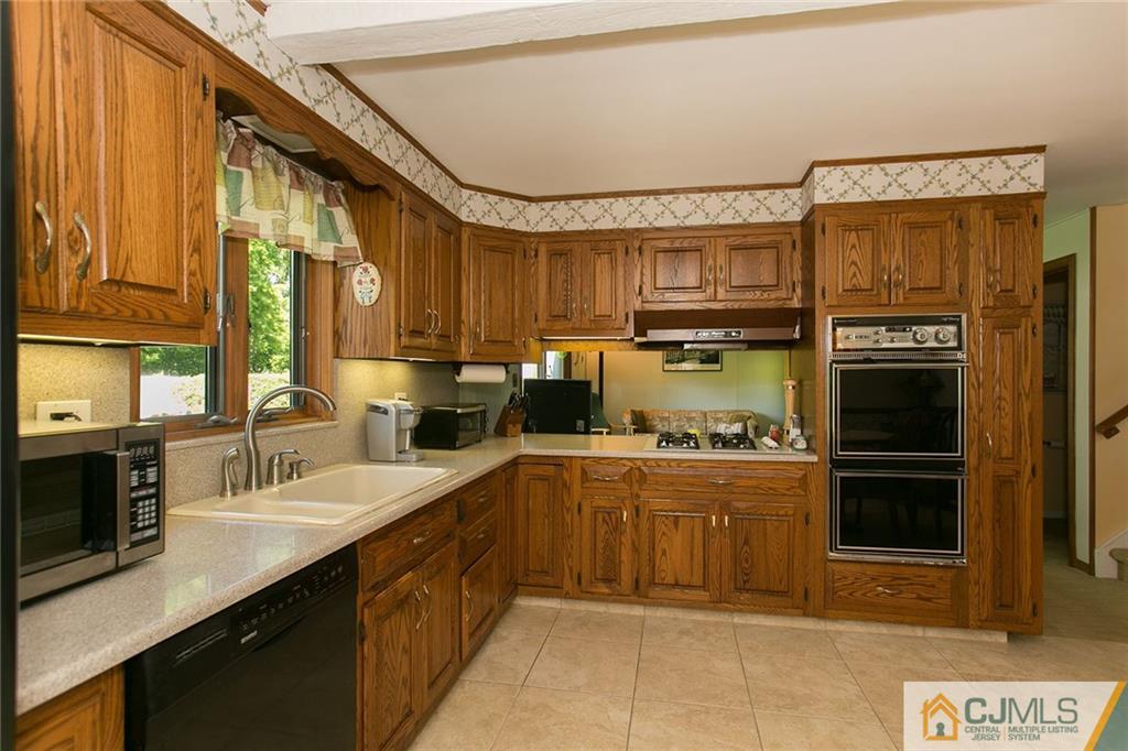 28 Timber Road Edison, NJ 08820 - Photo 14 of 23 a kitchen with stainless steel appliances granite countertop a stove sink and cabinets