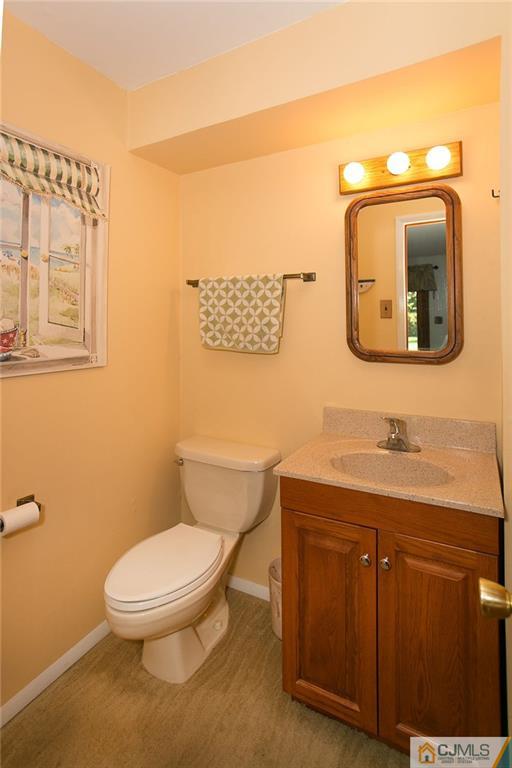 28 Timber Road Edison, NJ 08820 - Photo 17 of 23 a bathroom with a toilet a sink and mirror
