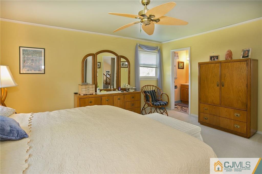 28 Timber Road Edison, NJ 08820 - Photo 19 of 23 a bedroom with a bed a dresser and mirror