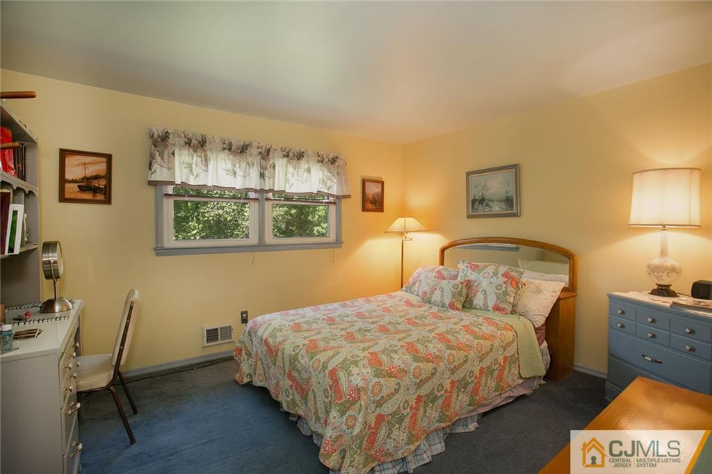 28 Timber Road Edison, NJ 08820 - Photo 21 of 23 a bedroom with a bed and a lamp on table