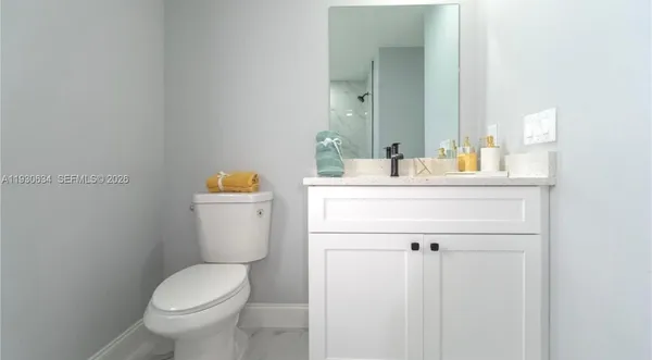 a bathroom with a sink a toilet and mirror
