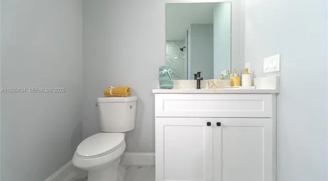 a bathroom with a sink a toilet and mirror