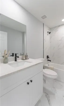 a bathroom with a double vanity sink toilet and a mirror