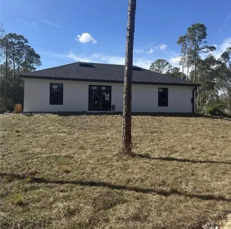 a house that has a tree in front of it