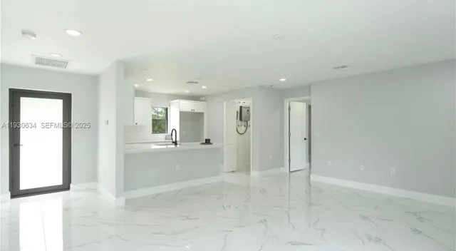 a view of a hallway with wooden shelves