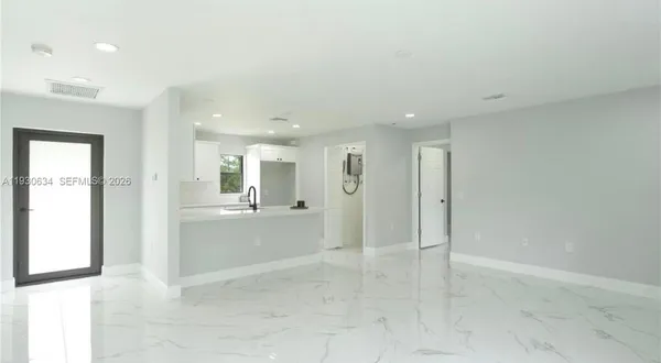a view of a hallway with wooden shelves