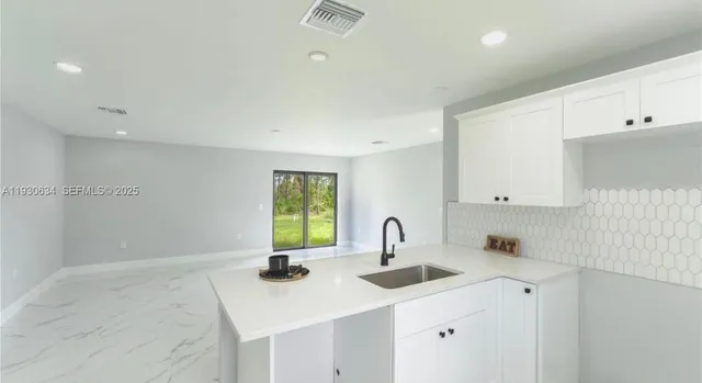 a kitchen with a sink cabinets and window