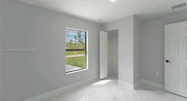 a view of an empty room with a window