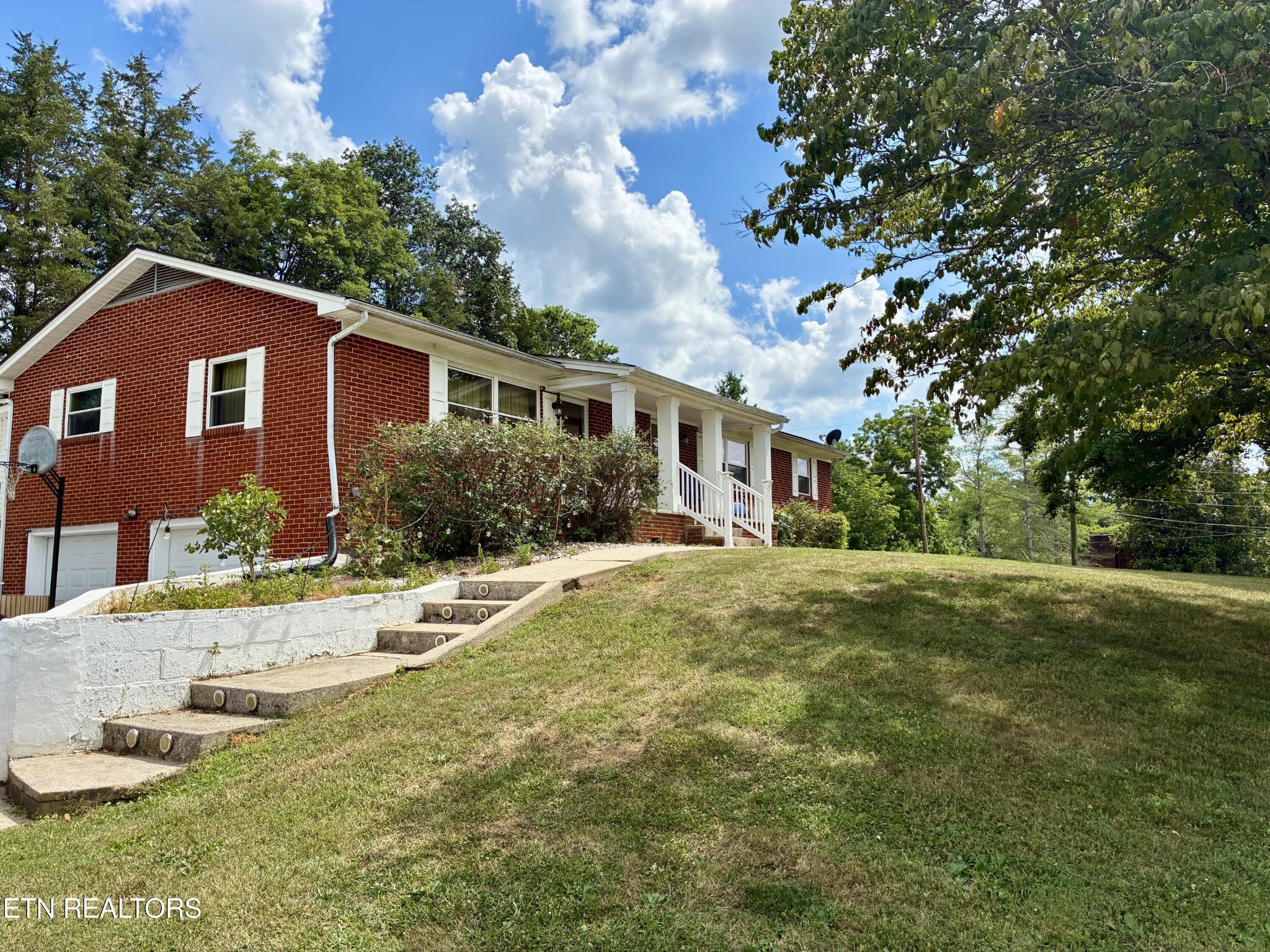 a front view of a house with garden