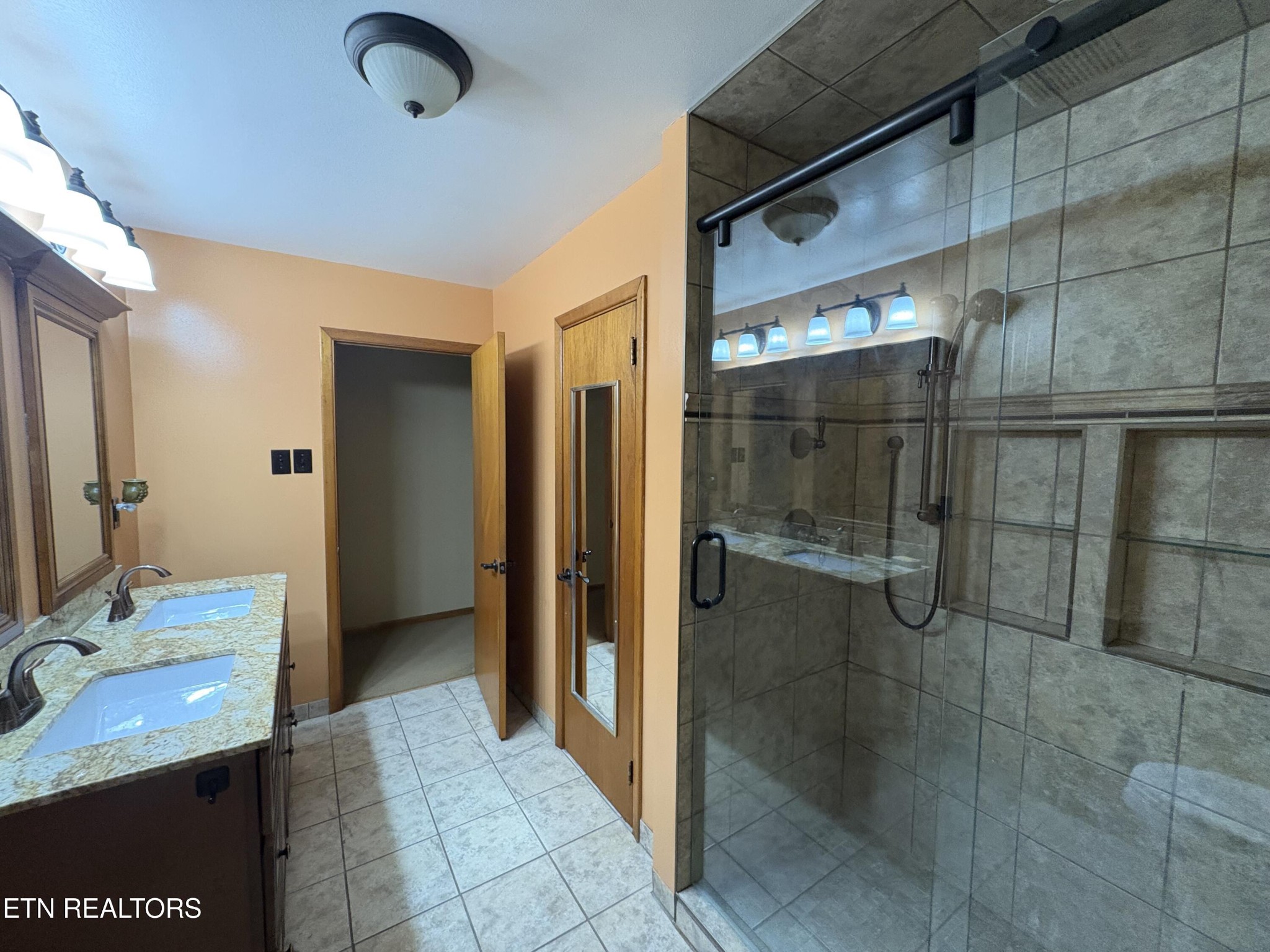 1907 Tazewell Pike Corryton, TN 37721 - Photo 23 of 42 a bathroom with a granite countertop sink a mirror and shower