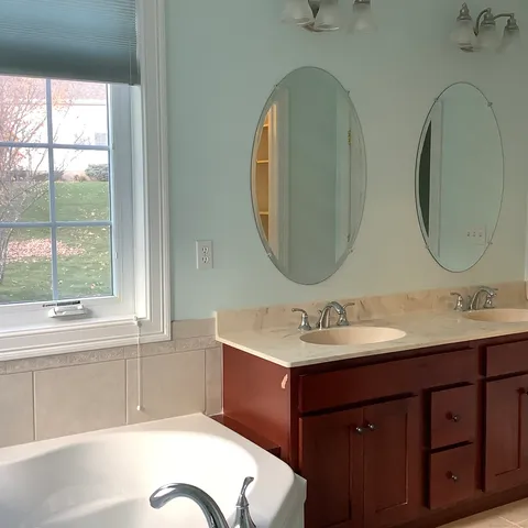 a view of a chandelier in big room with wooden floor