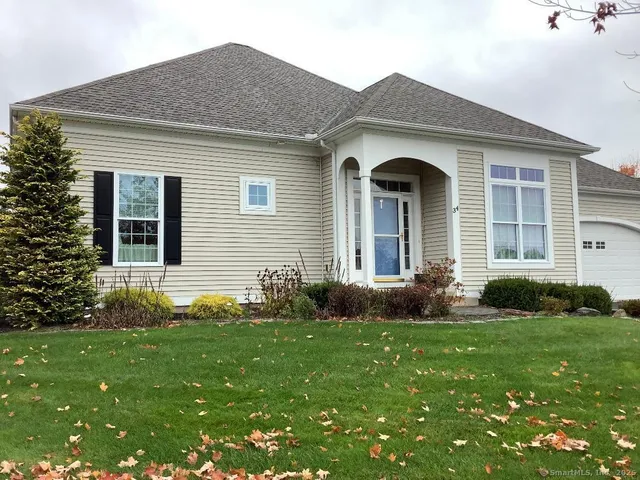 a front view of a house with garden and porch