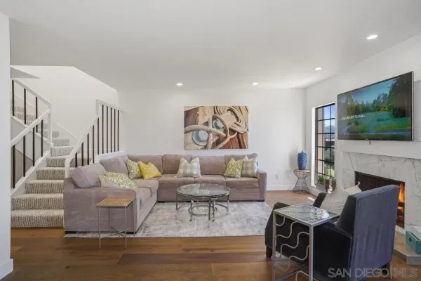 a living room with fireplace furniture and a flat screen tv