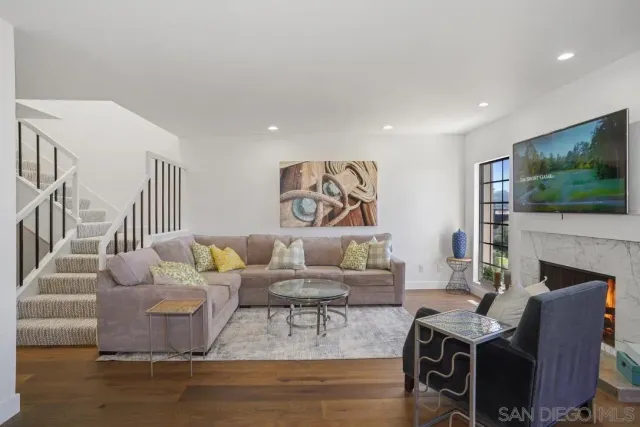 a living room with fireplace furniture and a flat screen tv