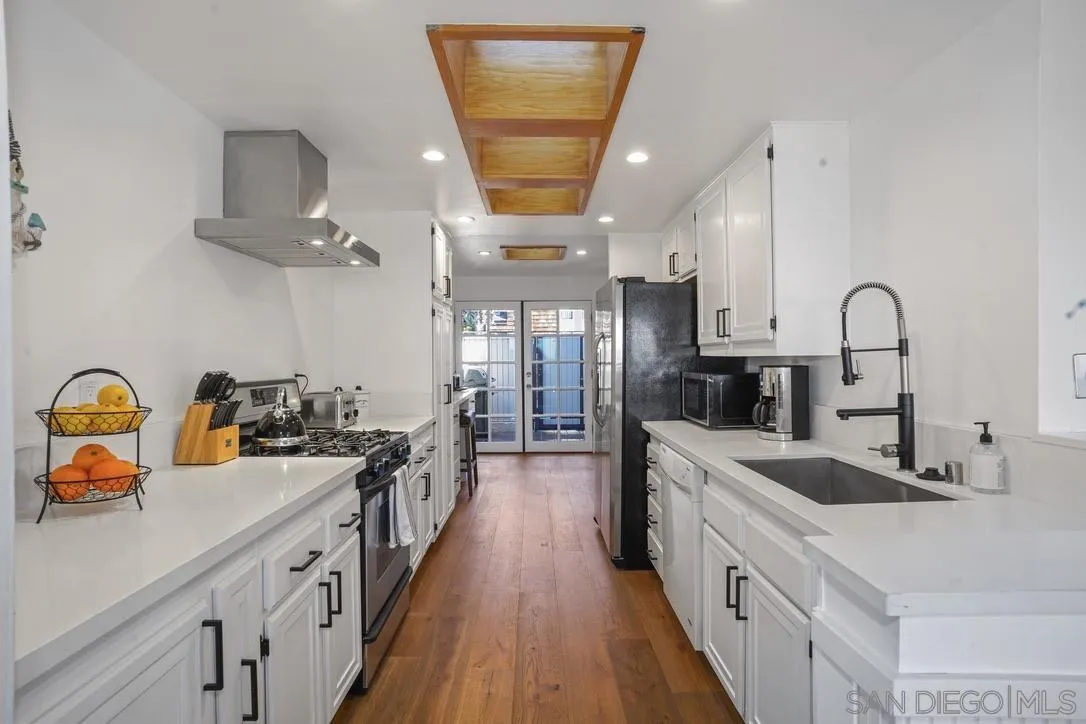 13053 Caminito Del Rocio Del Mar, CA 92014 - Photo 11 of 49 a kitchen with sink a stove and cabinets