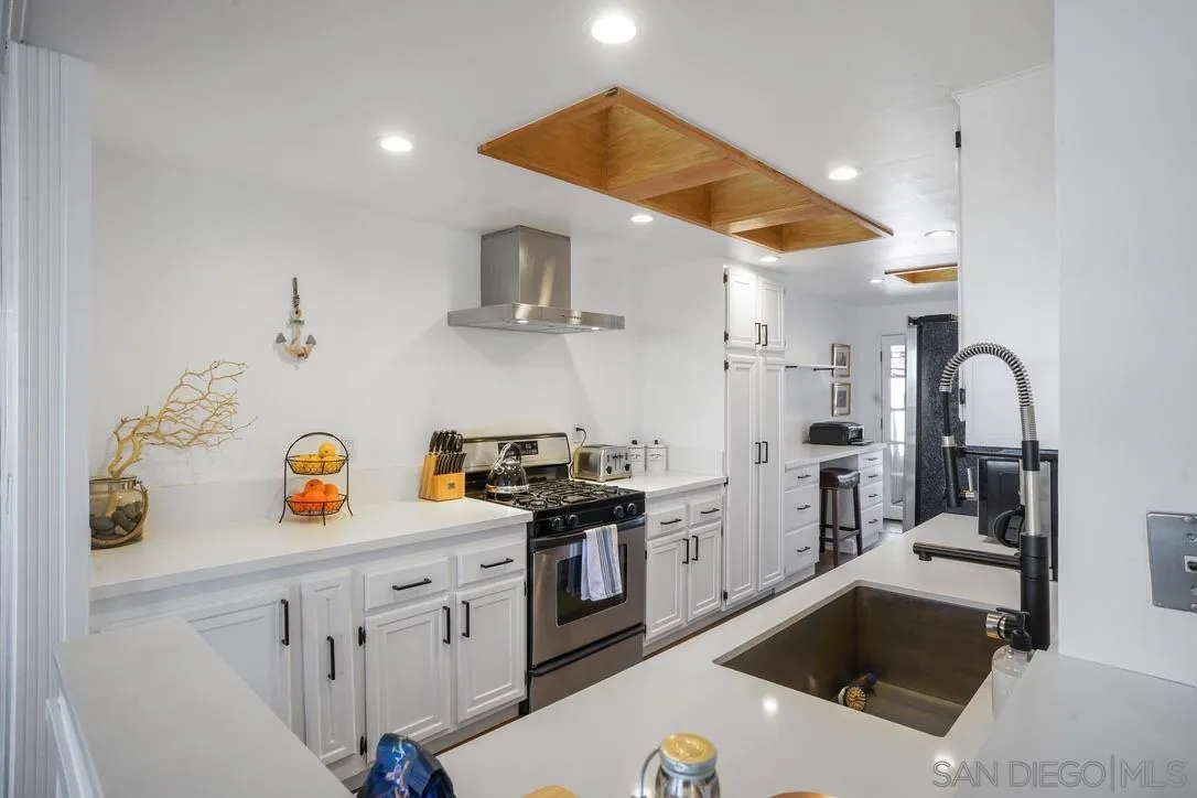 13053 Caminito Del Rocio Del Mar, CA 92014 - Photo 13 of 49 a kitchen with a sink a stove and cabinets