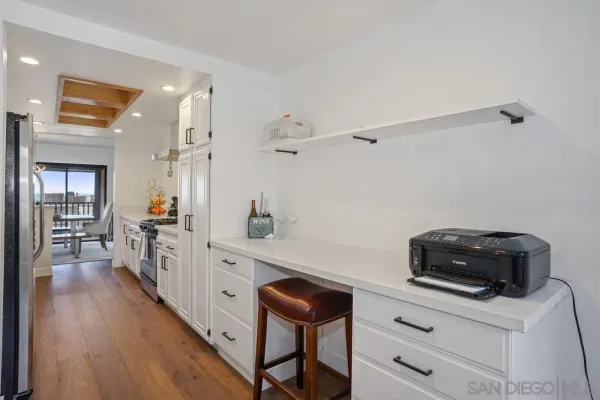 a kitchen with a refrigerator and a chair