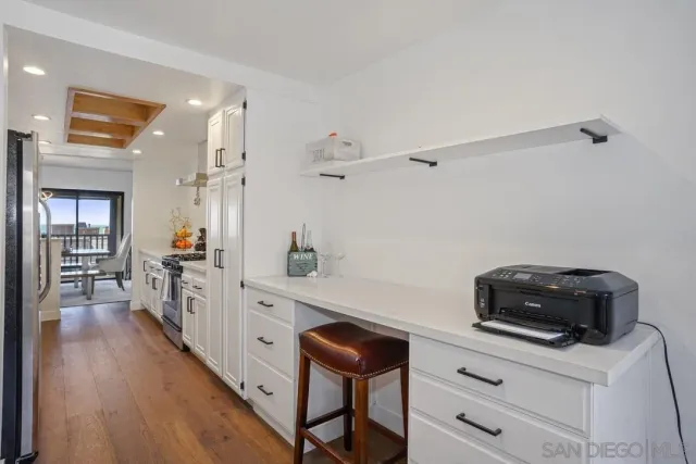 a kitchen with a refrigerator and a chair