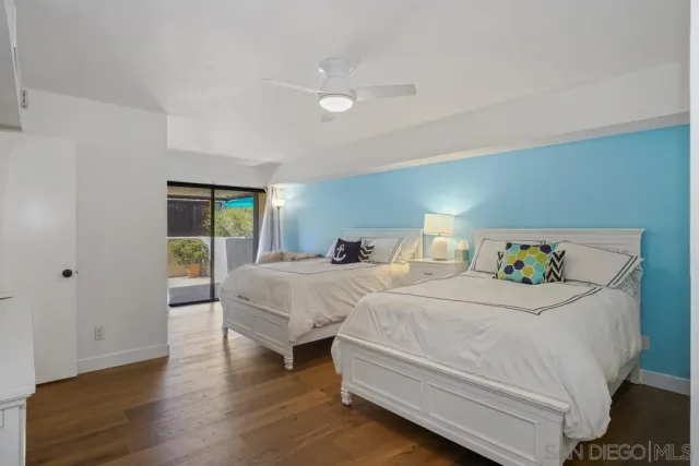 a bedroom with two beds and a window