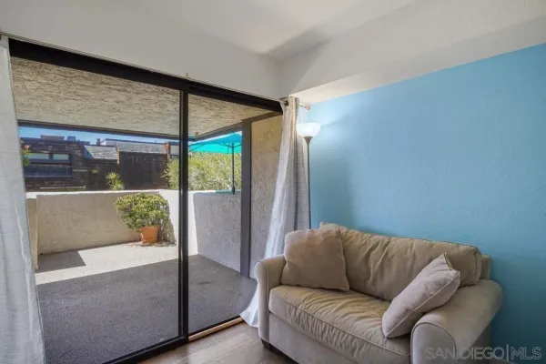 a living room with furniture and a floor to ceiling window