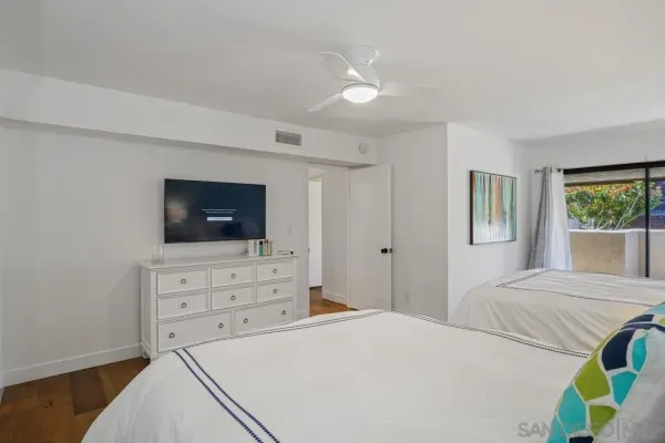a bedroom with a bed and a television