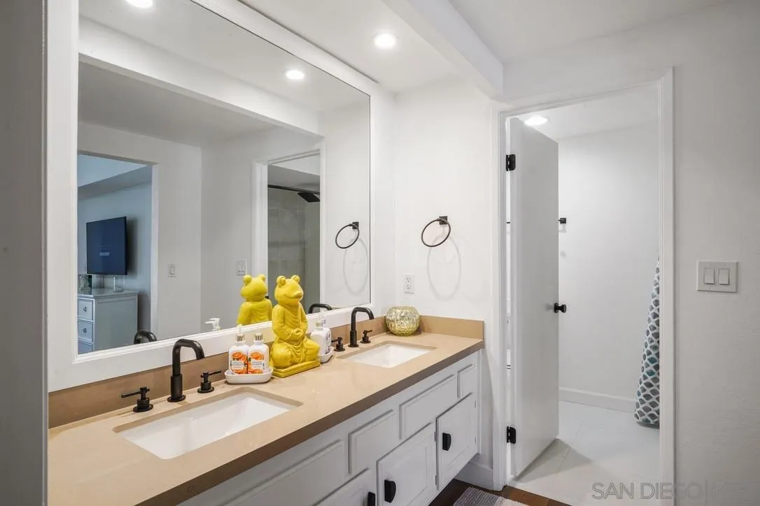 13053 Caminito Del Rocio Del Mar, CA 92014 - Photo 24 of 49 a bathroom with double vanity sinks and a mirror