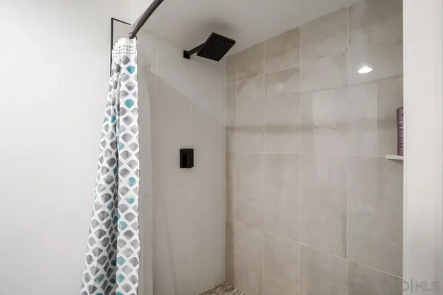 a bathroom with a shower curtain and a sink
