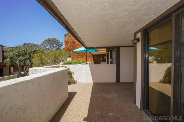 a view of a living room and a balcony