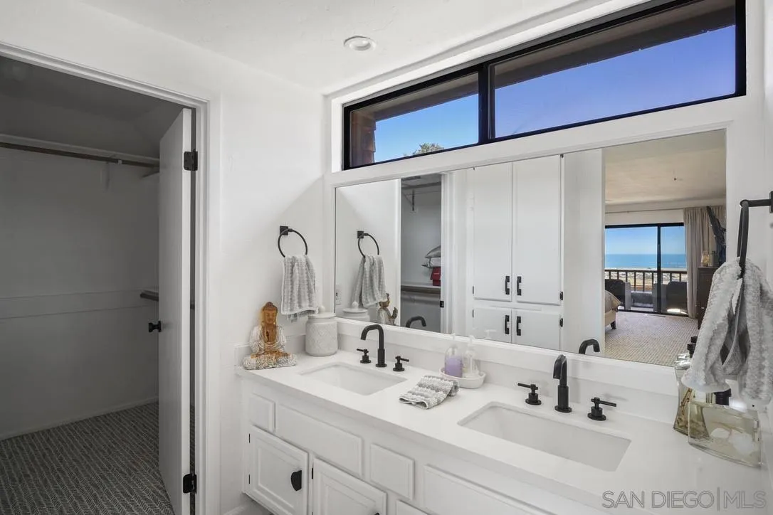 13053 Caminito Del Rocio Del Mar, CA 92014 - Photo 28 of 49 a bathroom with a sink and a mirror