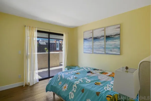 a bedroom with bed and balcony