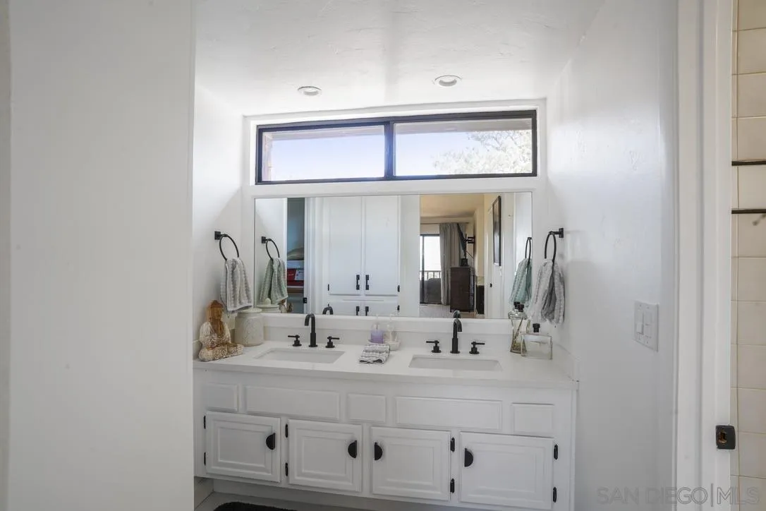 13053 Caminito Del Rocio Del Mar, CA 92014 - Photo 32 of 49 a bathroom with a sink and a mirror