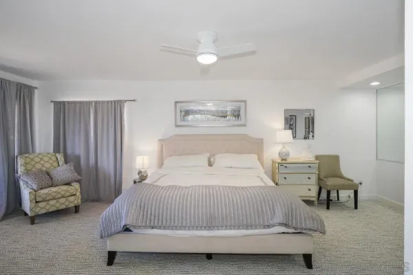 a bedroom with a bed and view of couch