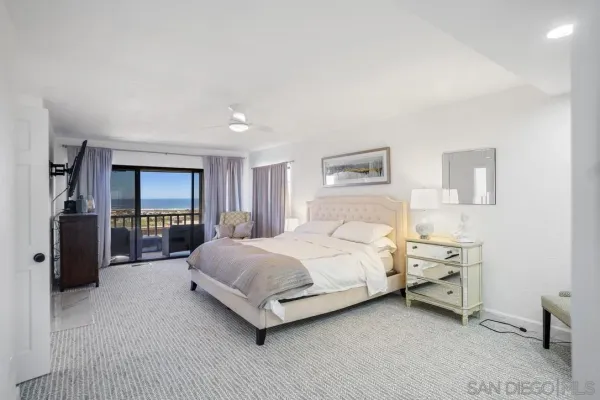 a spacious bedroom with a bed and a walk in closet