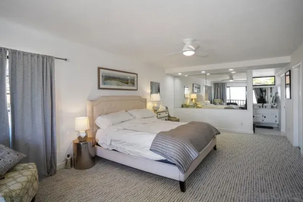 a spacious bedroom with a large bed and a view of bedroom