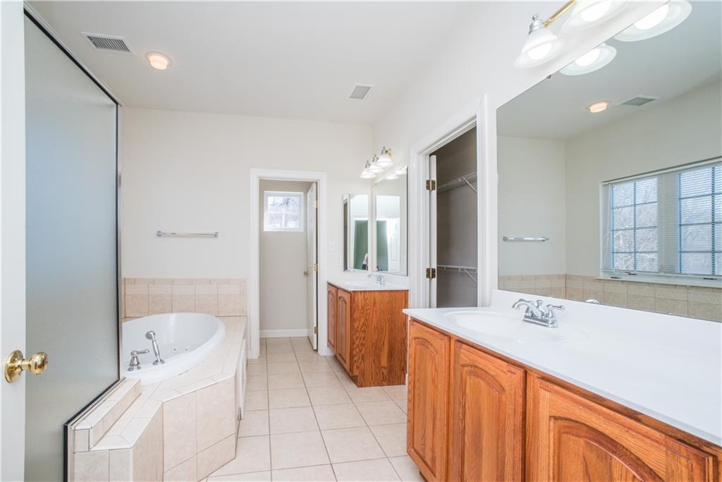 8404 David Drive Bridgeville, PA 15017 - Photo 12 of 25 a spacious bathroom with a tub sink and mirror