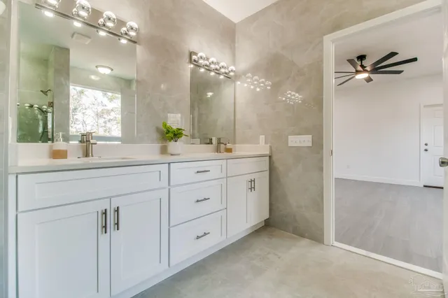 a bathroom with a double vanity sink mirror and