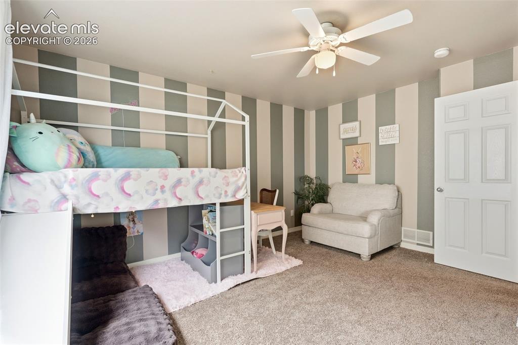 2264 Reed Grass Way Colorado Springs, CO 80915 - Photo 28 of 50 a living room with furniture and a fireplace