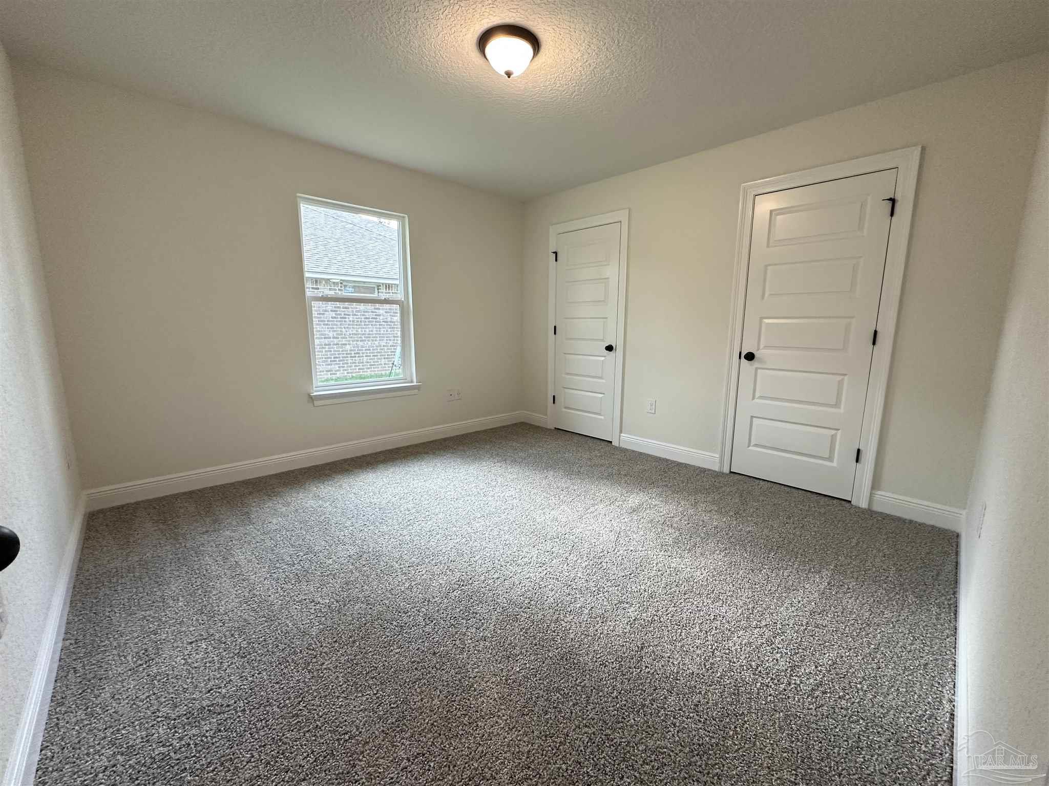 5214 Barnett Road Milton, FL 32583 - Photo 13 of 22 an empty room with windows and closet