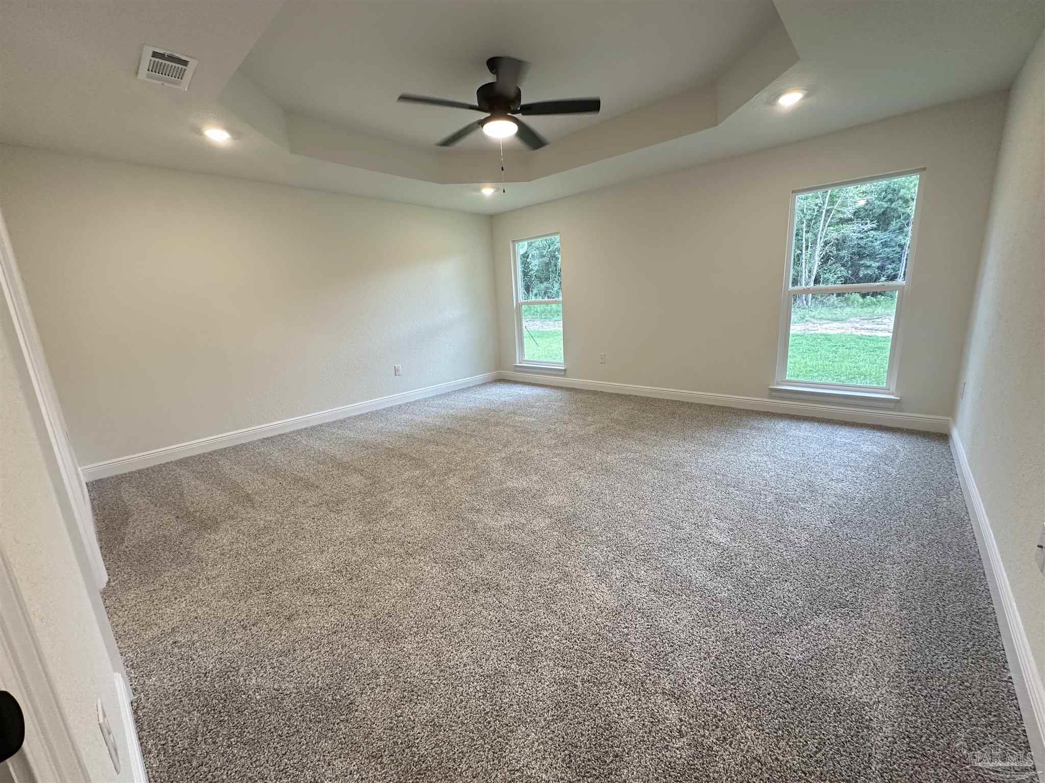 5214 Barnett Road Milton, FL 32583 - Photo 15 of 22 an empty room with windows and ceiling fan