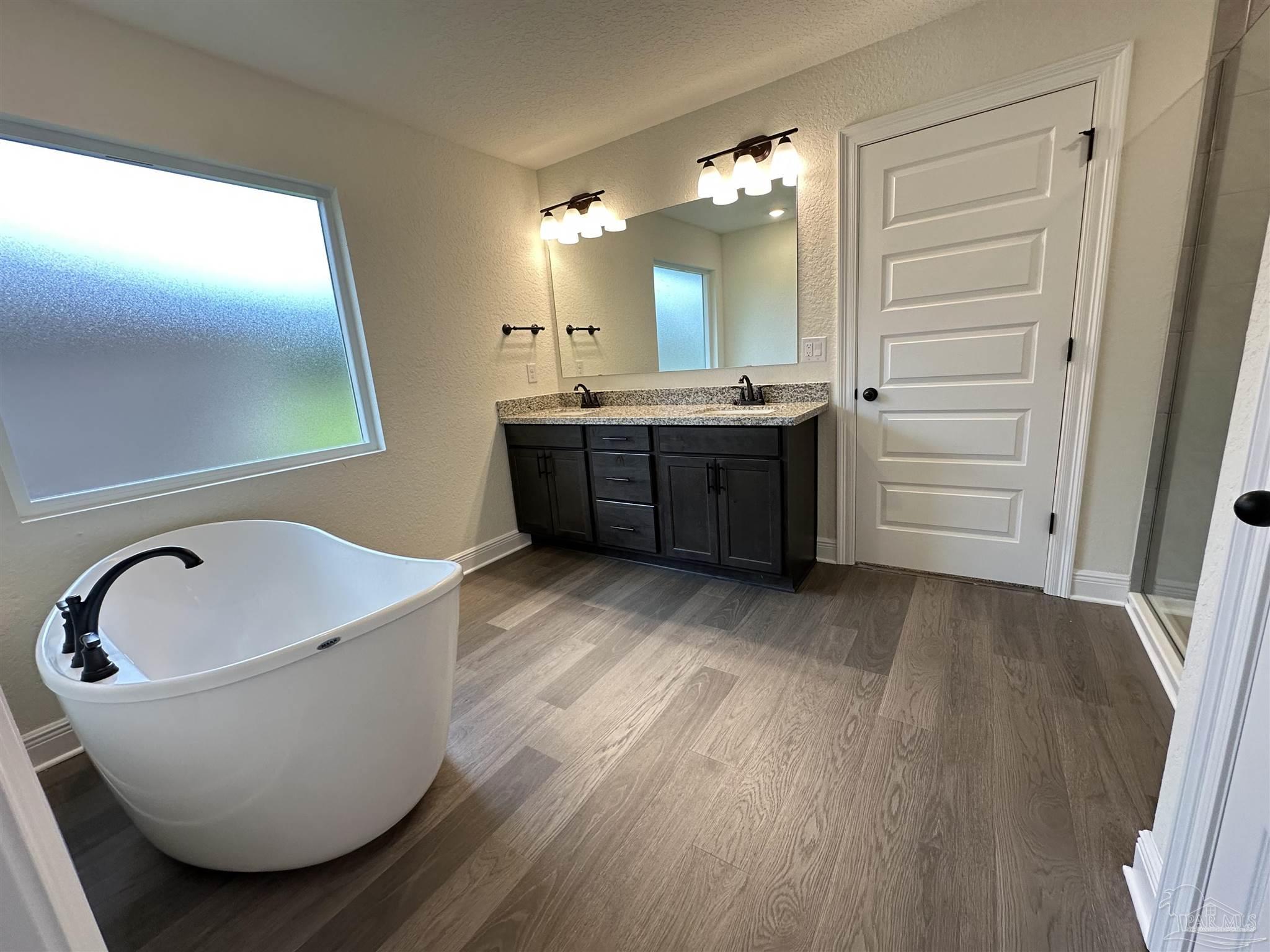 5214 Barnett Road Milton, FL 32583 - Photo 17 of 22 a bathroom with a bathtub sink and mirror